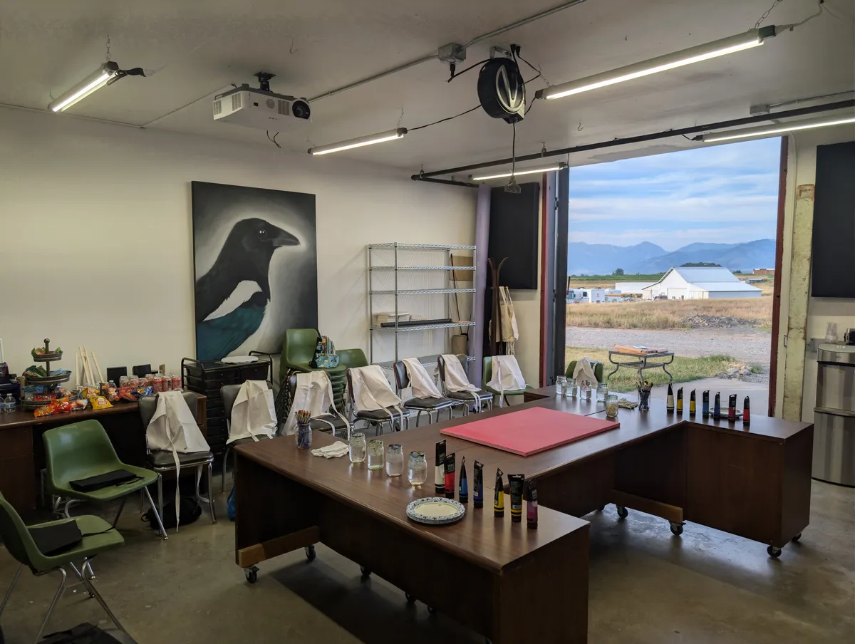 ArtLab classroom arranged for a painting event with mountain views through the open barn door